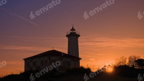Preview: The lighthouse at sunset on the beach at the mouth of the river Tagliamento, Bibione, Venezia, Italy