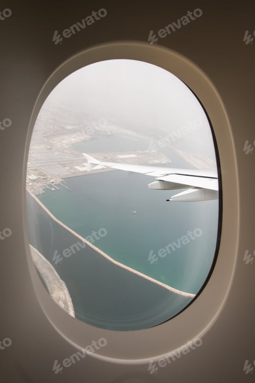 Preview: The plane-the view from the window of the porthole on the city Arab Emirates Dubai