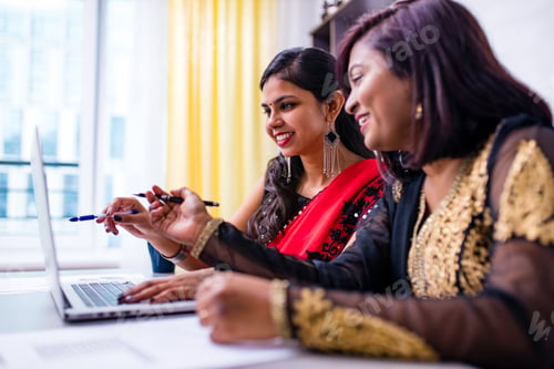 Preview: two beautiful women in tradition sari working at office or cafe