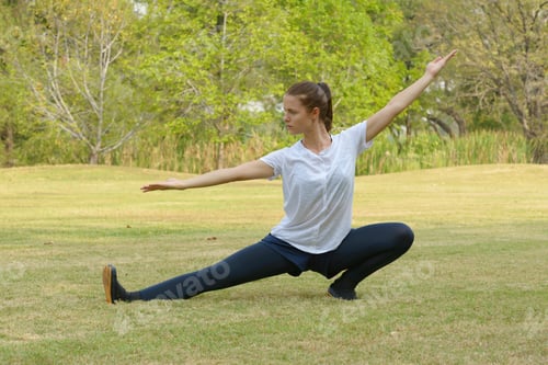 Preview: Young beautiful woman exercising at the park outdoors
