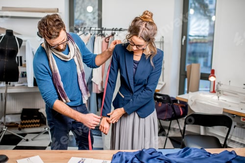 Preview: Fashion Designer Measuring a Sleeve in Modern Studio