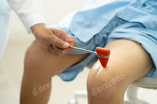 Preview: Asian doctor physiotherapist examining, massaging and treatment knee