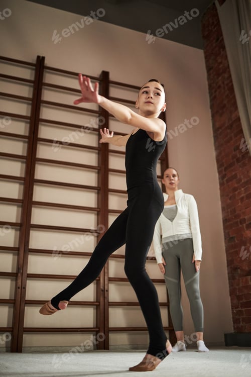 Preview: Teenage Caucasian Girl Practicing Ballet Dance While Young Woman Observing