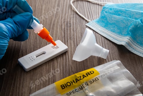 Preview: Hand with blue surgical glove placing the sample into the covid-19 antigen diagnostic test device