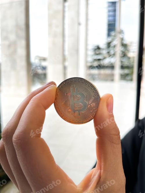 Preview: Female holding in her hand symbol of crypto currency .