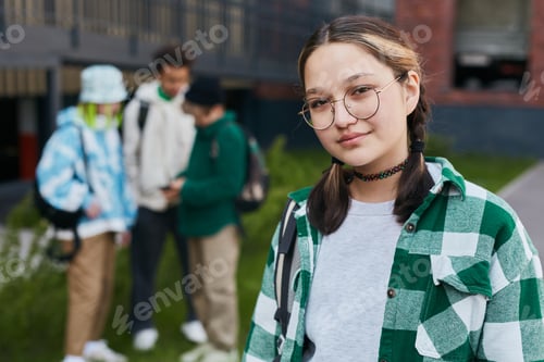 Preview: Young schoolgirl standing in school yard