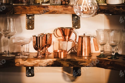 Preview: Kitchen shelves with various glassware, tumblers and utencils in daylight