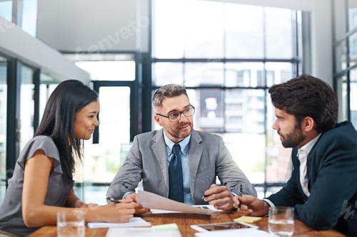 Preview: White collar confidence. Cropped shot of three businesspeople meeting in the boardroom.
