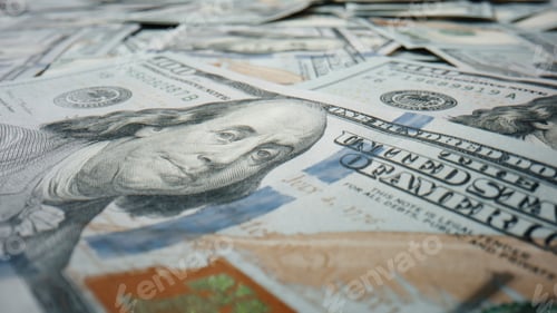 Preview: Closeup hundred dollar banknote lying on large heap american currency rotating.