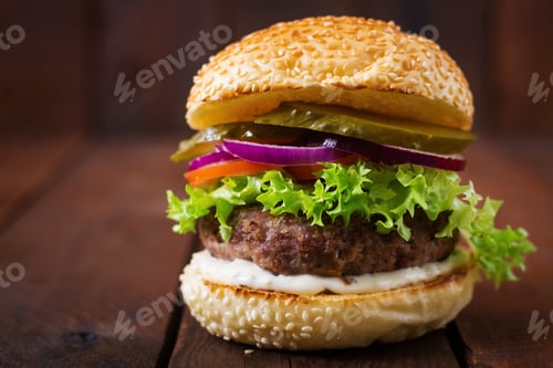 Preview: Big sandwich - hamburger burger with beef, pickles, tomato and tartar sauce on wooden background.