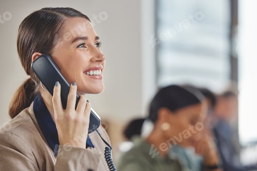 Preview: Shot of a young businesswoman talking on a telephone while working in a call centre