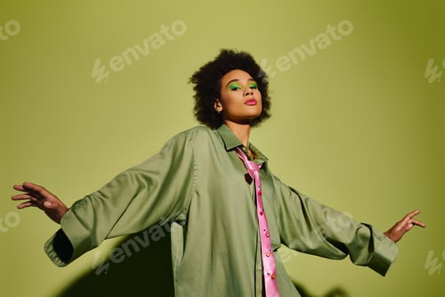 Preview: A young woman expresses emotion with style in a vibrant green setting during a reflective moment