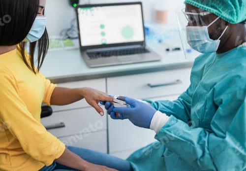 Preview: African male doctor using pulse oximeter on woman patient finger while wearing surgical face masks