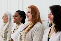 Preview: Four Happy Women Sitting Together Smiling