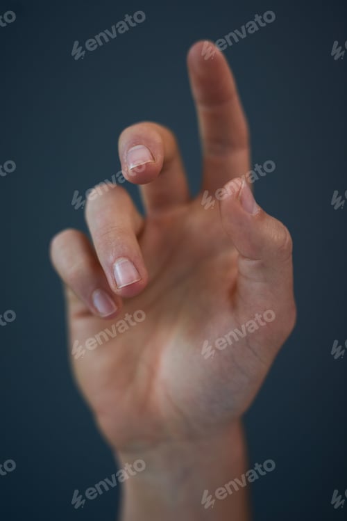 Preview: Reach out and lend a hand. Studio shot of an unrecognizable mans hand against a blue background.