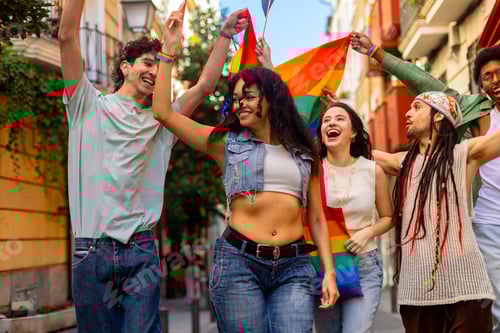 Preview: Young activists holding rainbow flag, celebrating gay pride in the city