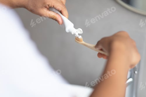 Preview: Daily dental care. Male hands pouring toothpaste on toothbrush, enjoying dental hygiene, closeup