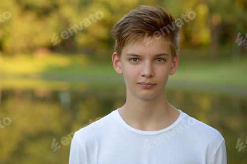 Preview: Young handsome teenage boy at the park outdoors