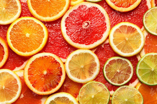 Preview: Slices of fresh citrus fruits as background, top view