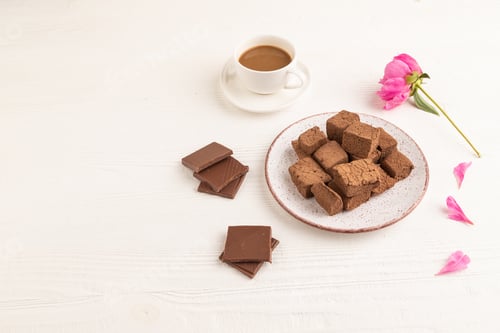 Preview: Chocolate marshmallow with cup of coffee on white wooden. side view, copy space.