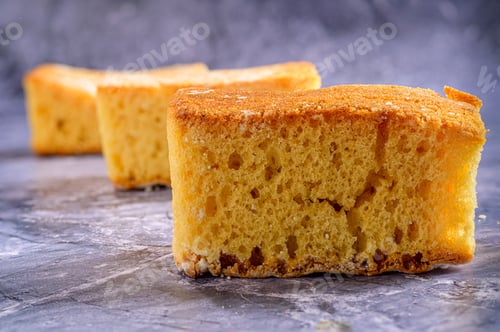 Preview: Golden sponge cake slices on gray surface