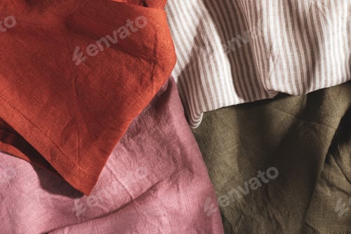 Preview: Pile of multicolored cotton and linen serving napkins
