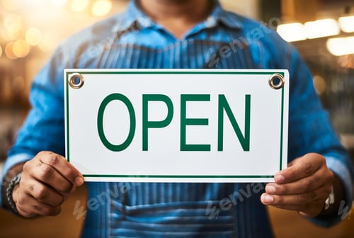 Preview: Closeup shot of an unrecognizable man holding up an open sign in his store
