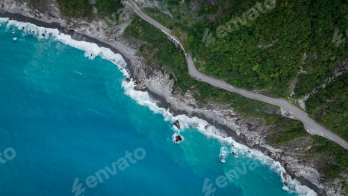 Preview: Scenic coastal road in Taiwan with turquoise waters and lush greenery on a sunny day