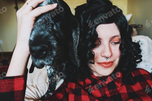Preview: Cute shot of a young woman spending time with her dog