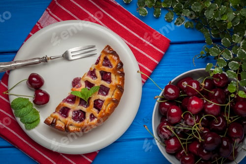 Preview: Homemade cherry pie on blue table.