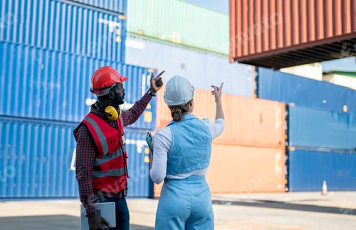 Preview: Foreman control loading Containers box from Cargo freight ship for import export.