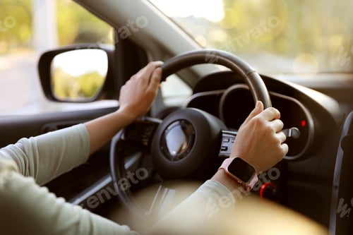 Preview: Woman behind steering wheel of modern car, closeup