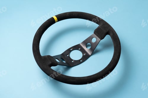 Preview: the isolated car steering wheel on the flat surface, simple transportation concept