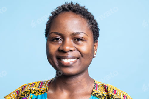 Preview: Portrait of cheerful female model posing over blue background
