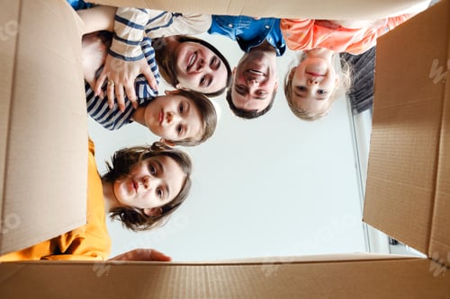 Preview: Happy family looking into cardboard box