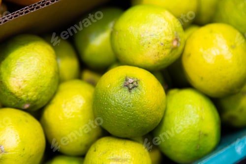 Preview: Colorful background of fresh picked, seasonal bright green lime citrus exotic fruit