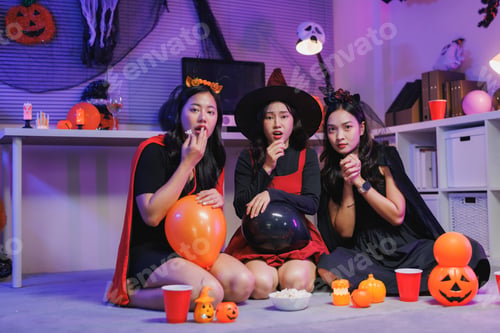 Preview: Young women watching scary movie during halloween party