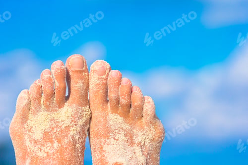 Preview: Close up of female feet on white sandy beach