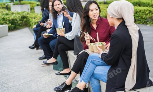 Preview: Multiethnic business people doing lunch break outdoor from office building