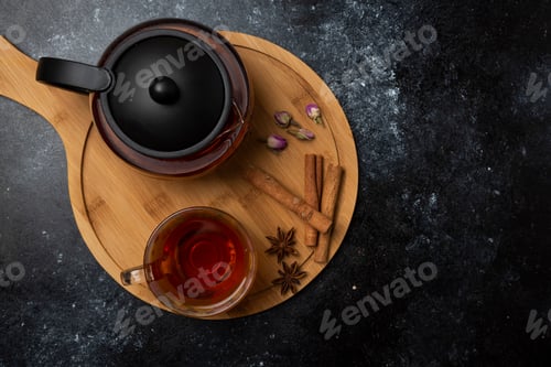 Preview: Herbal winter tea in the cups with spices on a wooden platter