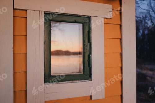 Preview: yellow wooden cabin in a sunset light