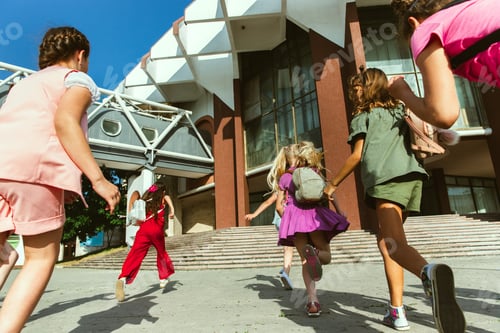 Preview: Happy kids playing at city's street in sunny summer's day