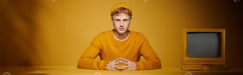 Preview: redhead presents his stylish winter outfit, sitting in a studio near vintage television