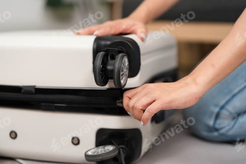 Preview: Packing for Travel. A woman organizing her suitcase at home, preparing for a trip.