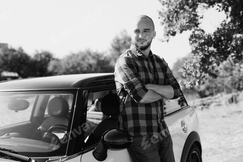 Preview: Guy in a plaid shirt next to a white car