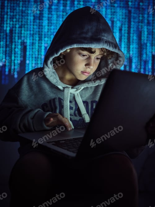 Preview: Serious boy using laptop on binary code background