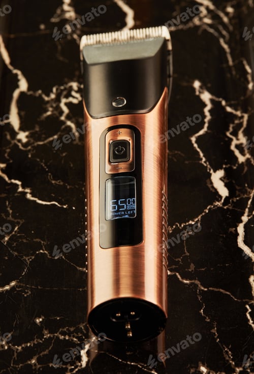 Preview: Electric hair clipper on a black marble background.