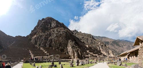 Preview: Ancient ruins nestled in a majestic mountainous landscape under a vast blue sky.