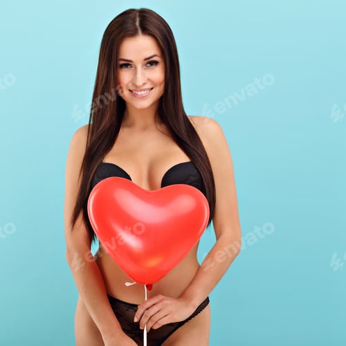 Preview: Sexy woman in underwear posing against blue background