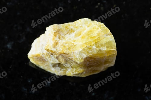 Preview: sample of rough yellow tourmaline mineral on black